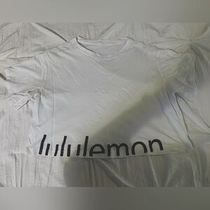 Lululemon cropped white T-shirt with black logo writing. Size small/4